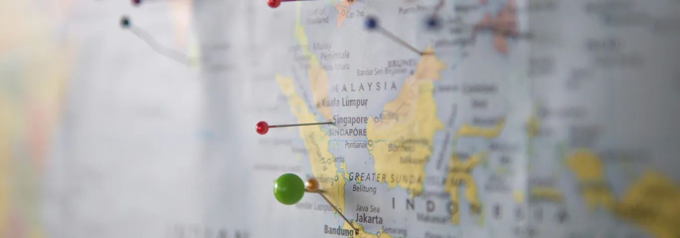 "World map with multi-colored pins in various locations"