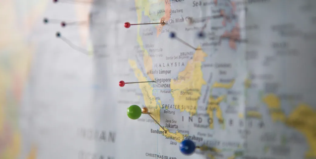 "World map with multi-colored pins in various locations"